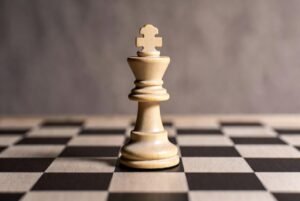 Alt text: Intense chess match concludes with a strategic checkmate, exuding victory and focus.